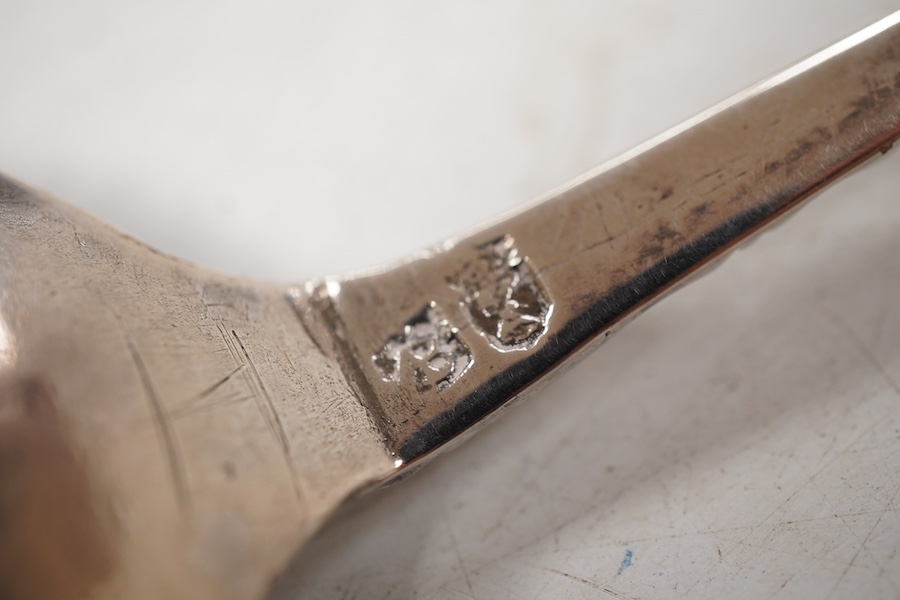 A late 18th/early 19th century Swedish? white metal spoon, with pierced parcel gilt finial, indistinct marks on the stem, 15cm.